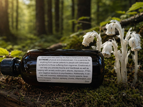 Bottle with label on a log in a forest with white flowers